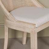 Light Wooden Sloped Rattan Upholstered Dining Chair with birch wood frame and linen seat in neutral tones