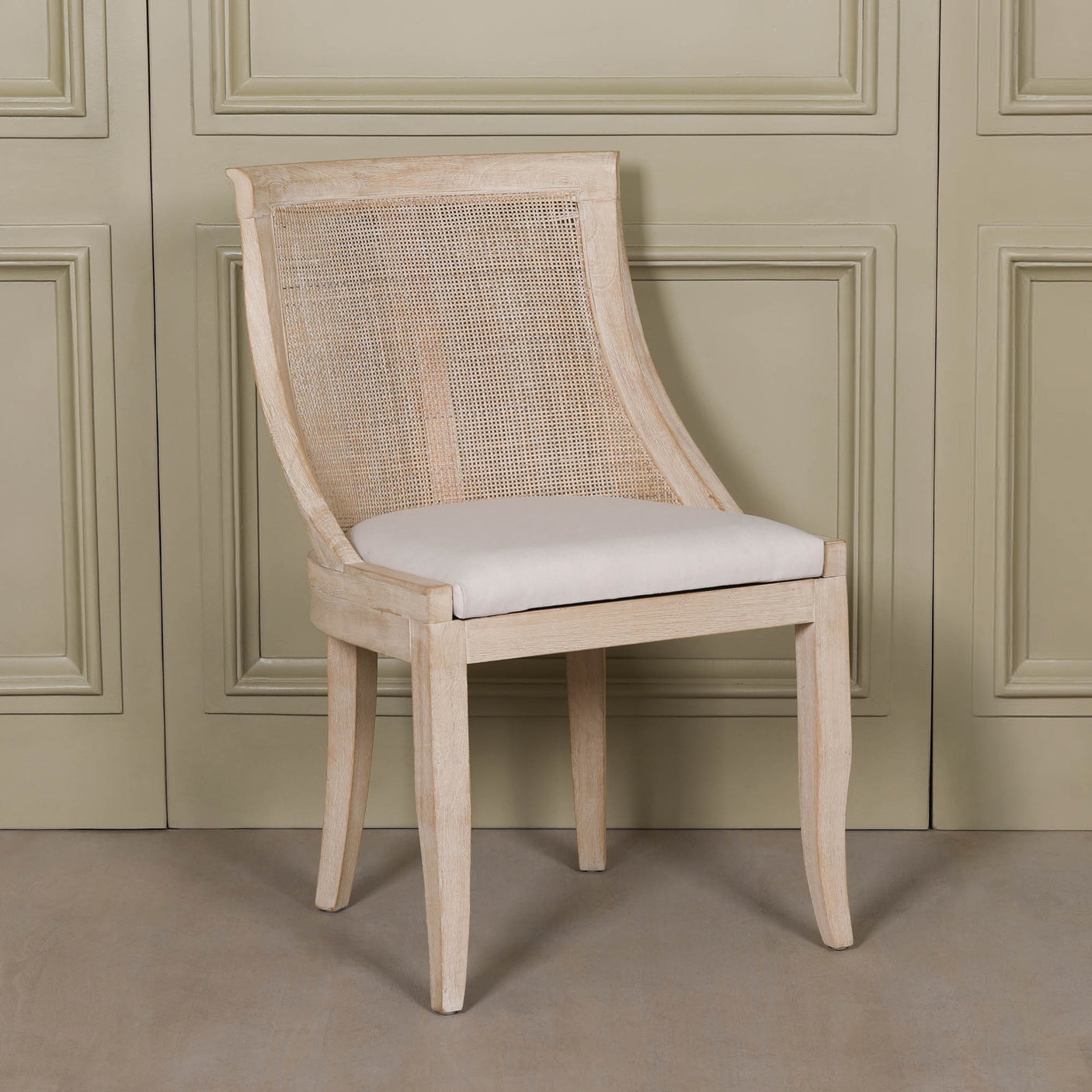 Light Wooden Sloped Rattan Upholstered Dining Chair with birch wood frame and linen seat in neutral tones