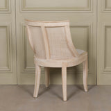Light Wooden Sloped Rattan Upholstered Dining Chair with birch wood and linen in a natural finish
