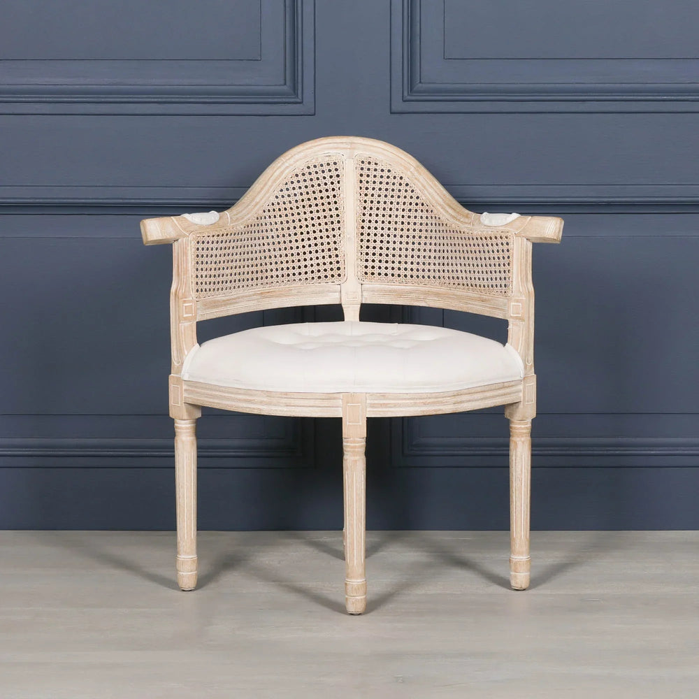 Natural wood occasional chair with cane backrest and cream upholstered seat