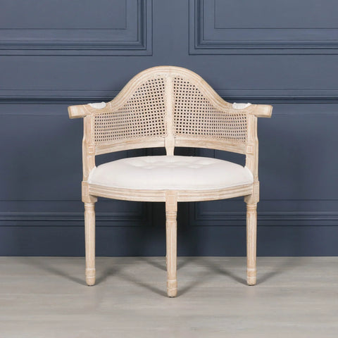 Natural wood occasional chair with cane backrest and cream upholstered seat