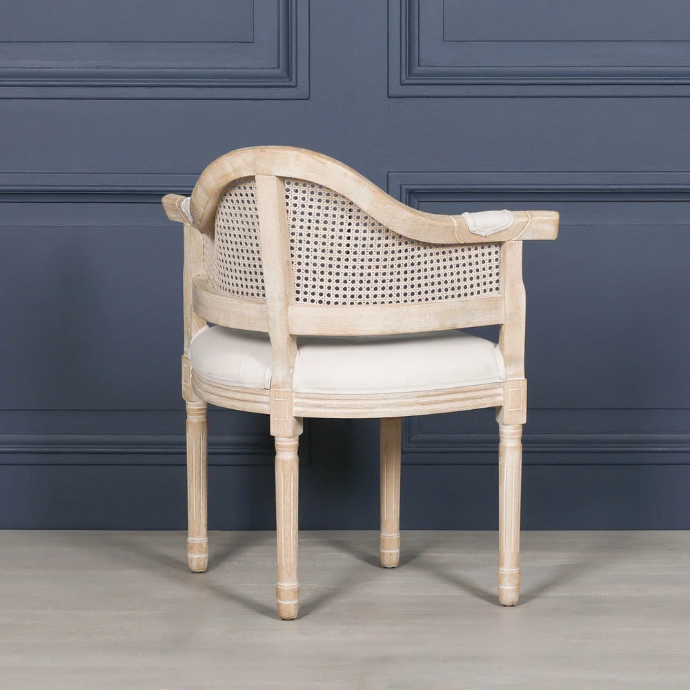 Oak cane back accent chair with round padded seat and curved frame