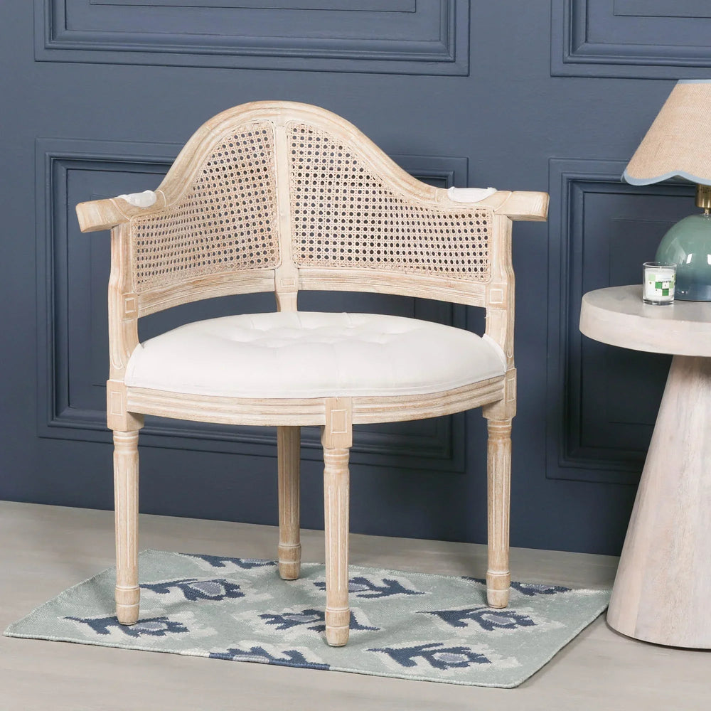 Light wood accent chair with cane back and white cushioned seat in modern living room