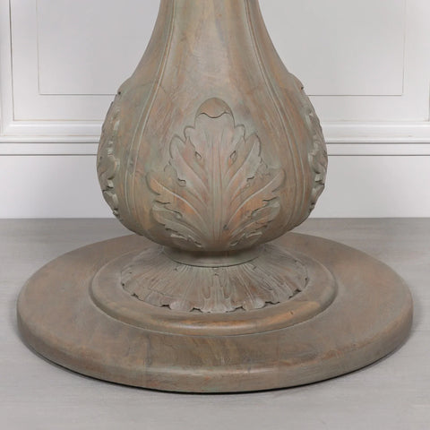 Carved wood dining table pedestal base with leaf detailing on round plinth