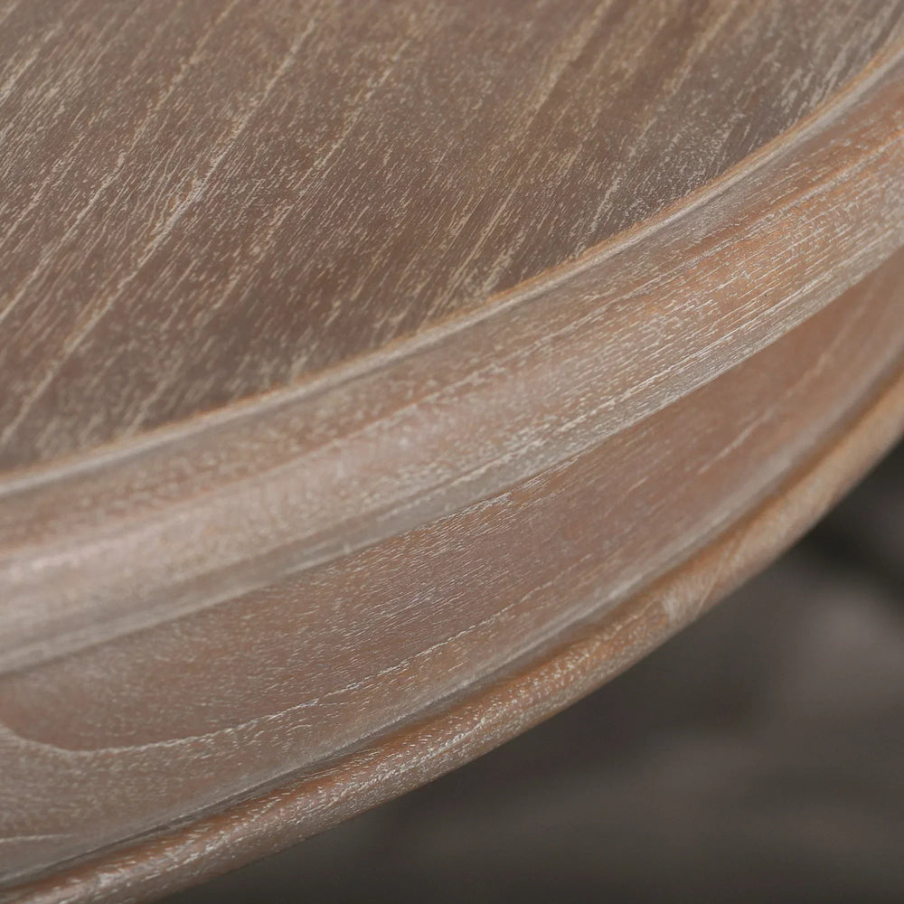 Closeup of round wooden table edge with natural grain texture