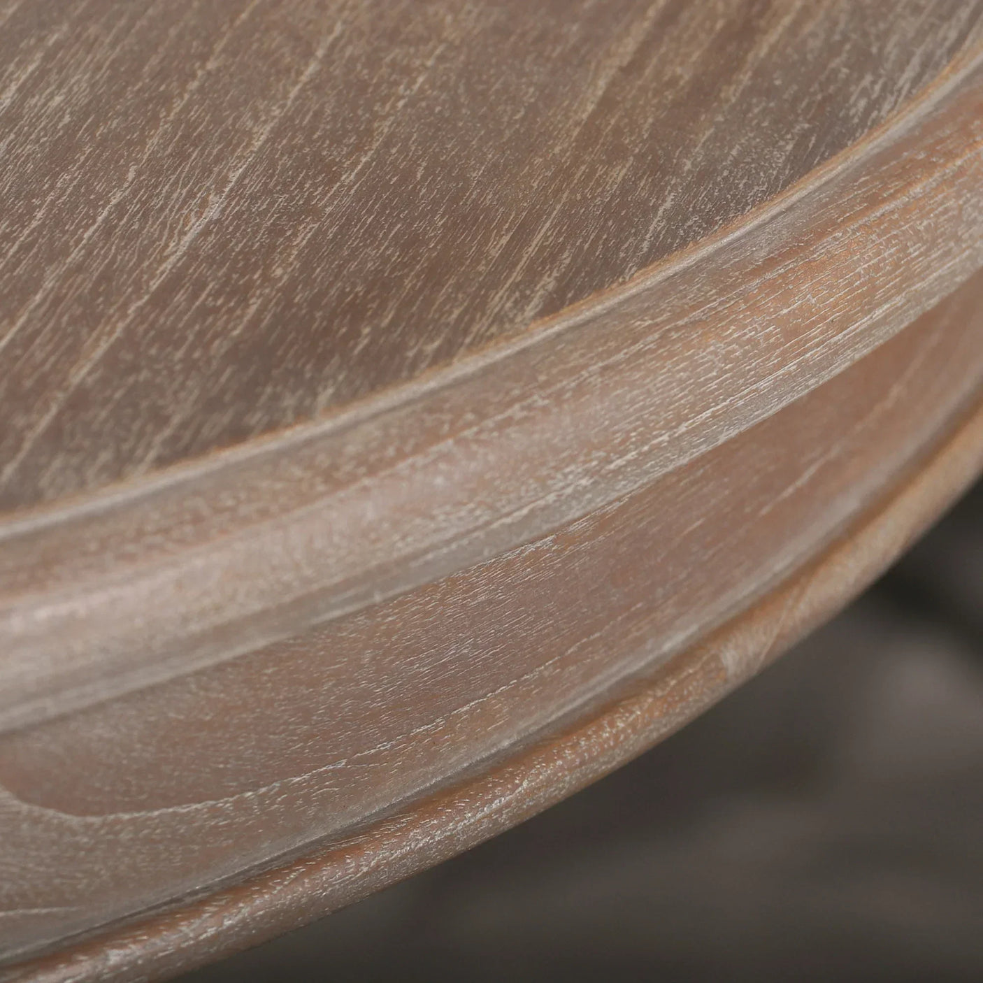 Closeup of round wooden table edge with natural grain texture