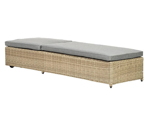 Rattan sunlounger with grey cushions, rectangular shape, side angle view