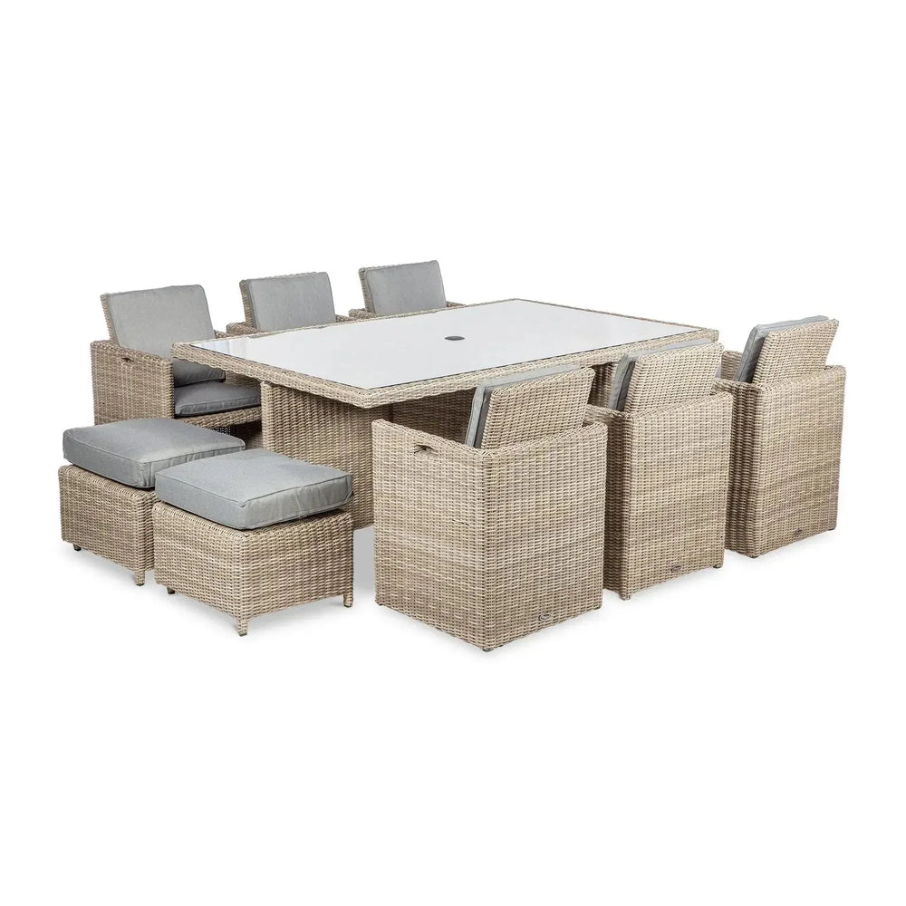 Rattan garden dining set with rectangular table, cushioned chairs and footstools