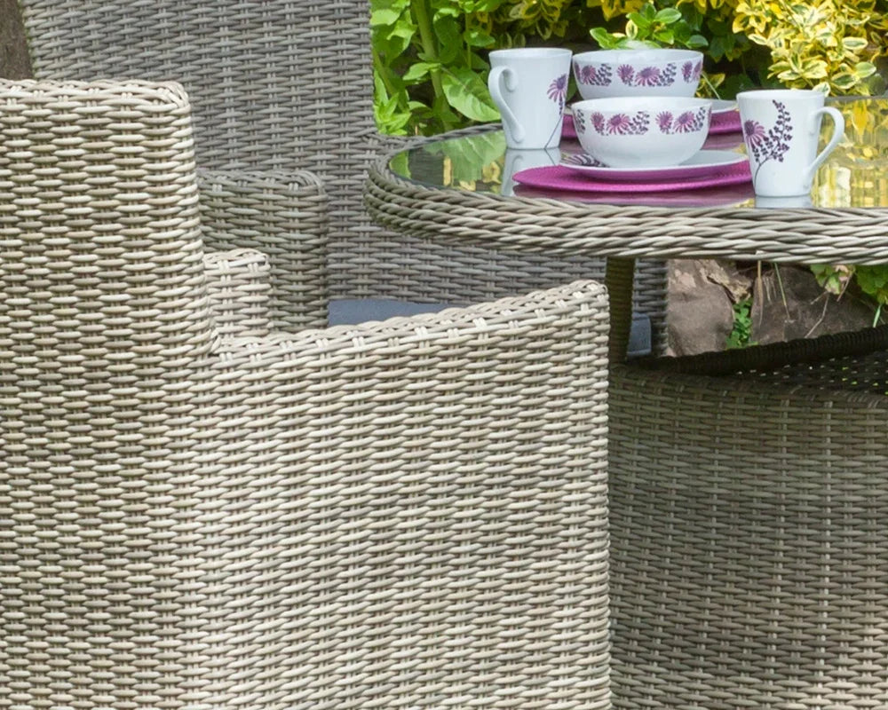 Close-up of rattan garden dining set with glass top table and outdoor dining chairs