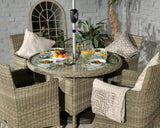 Round rattan garden dining set with four cushioned chairs and glass top table fully set