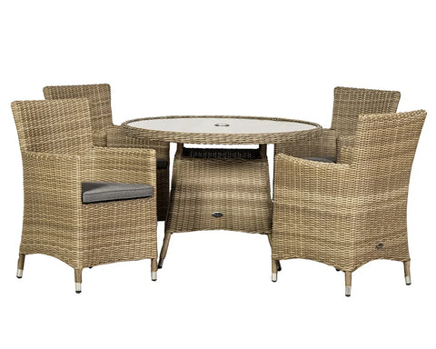 Rattan garden dining set with round glass table and four cushioned armchairs
