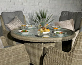 Round rattan dining set with glass top, grey cushions and place settings for four