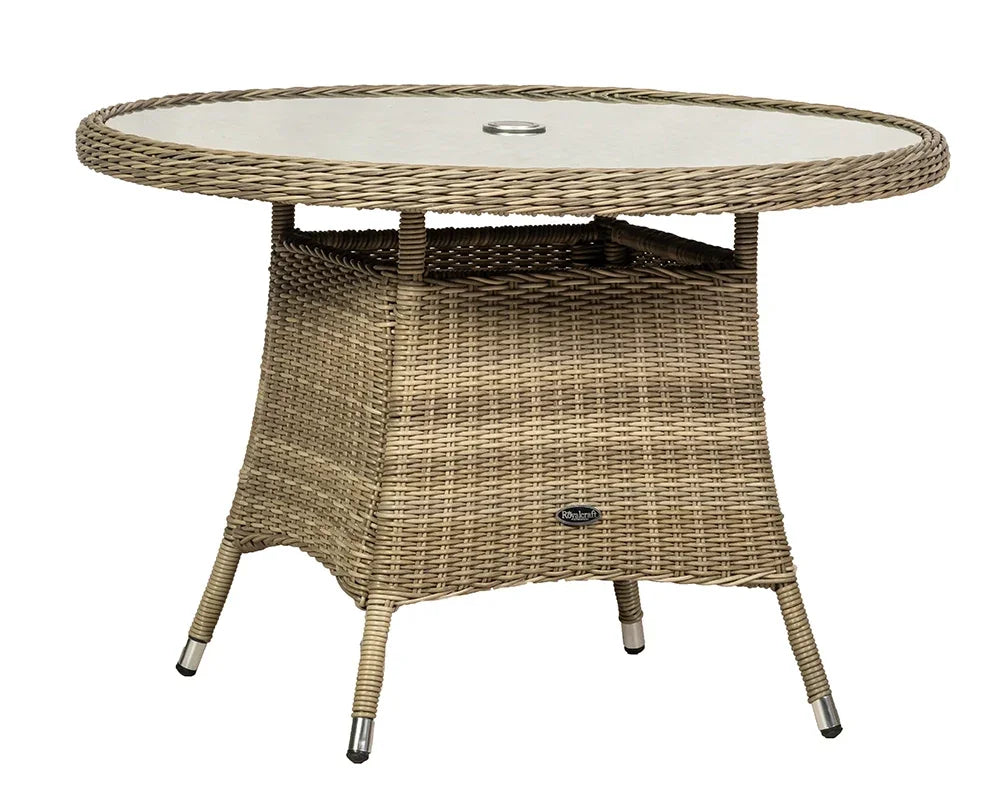 Round rattan outdoor dining table with glass top and central umbrella hole