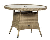 Round rattan outdoor dining table with glass top and central umbrella hole