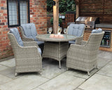 Grey rattan patio dining set with glass-top table and cushioned armchairs in outdoor setting