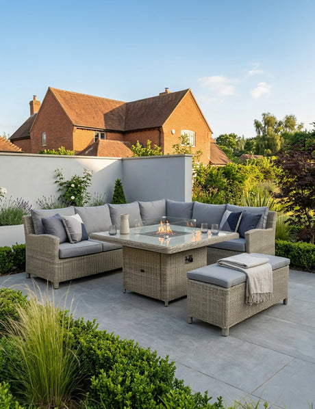 Rattan outdoor corner sofa set with fire pit table and bench on tiled patio