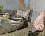 Rattan garden dining set with glass table, grey patterned cushion, outdoor place settings