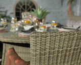 Close-up of rattan garden dining set with glass table and neutral weave chair