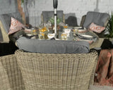 Rattan garden dining set with grey seat cushions and glass table set for outdoor meal