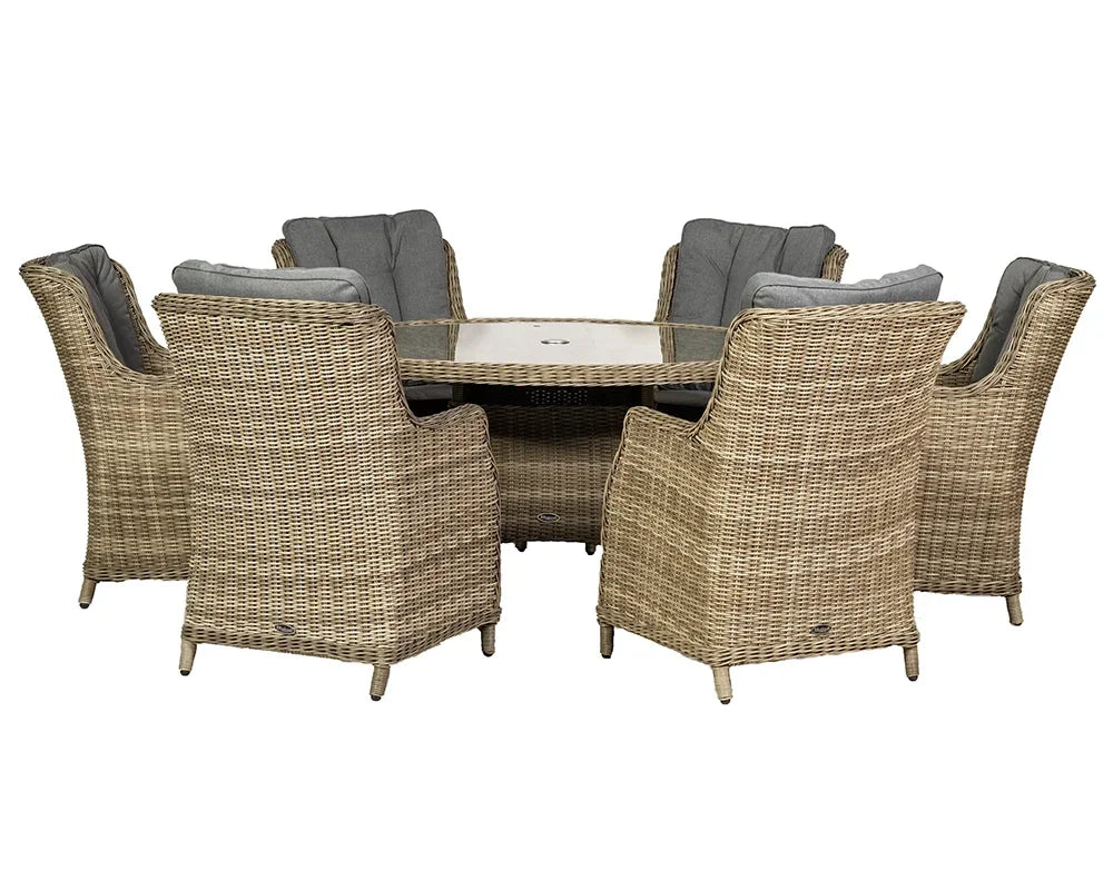 Rattan outdoor dining set with six cushioned armchairs and round glass table