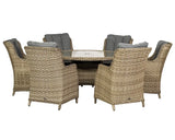 Rattan outdoor dining set with six cushioned armchairs and round glass table