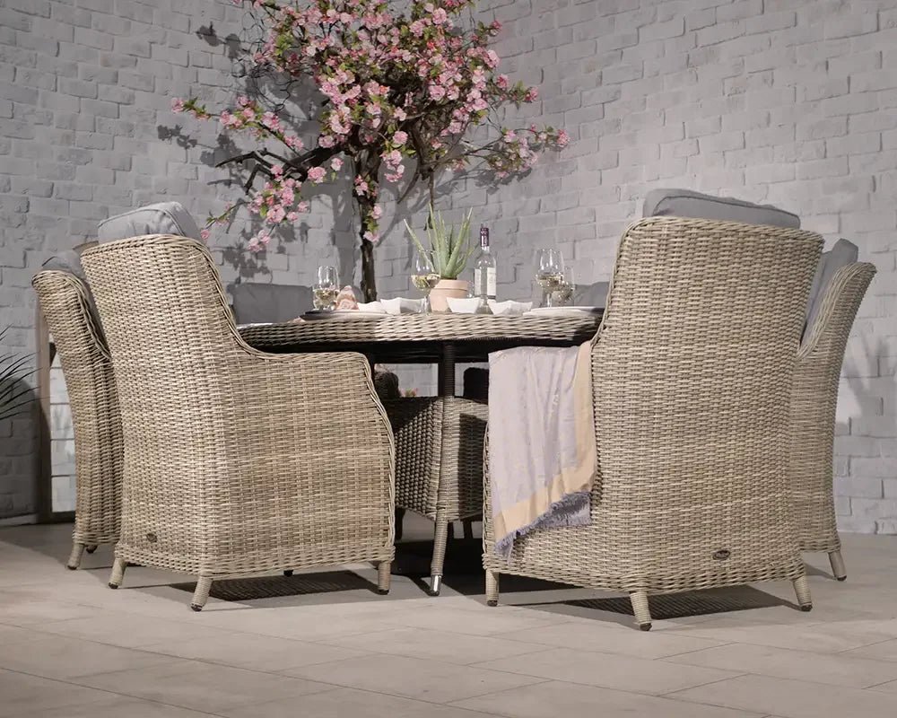 Rattan dining set with six cushioned chairs and round table in modern patio setting