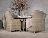 Rattan dining set with six cushioned chairs and round table in modern patio setting