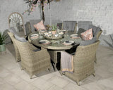 Rattan garden dining set with six chairs, grey cushions, and round glass table top