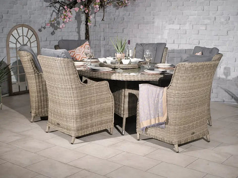 Rattan outdoor dining set with cushioned chairs and round table set for six
