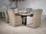 Rattan outdoor dining set with cushioned chairs and round table set for six
