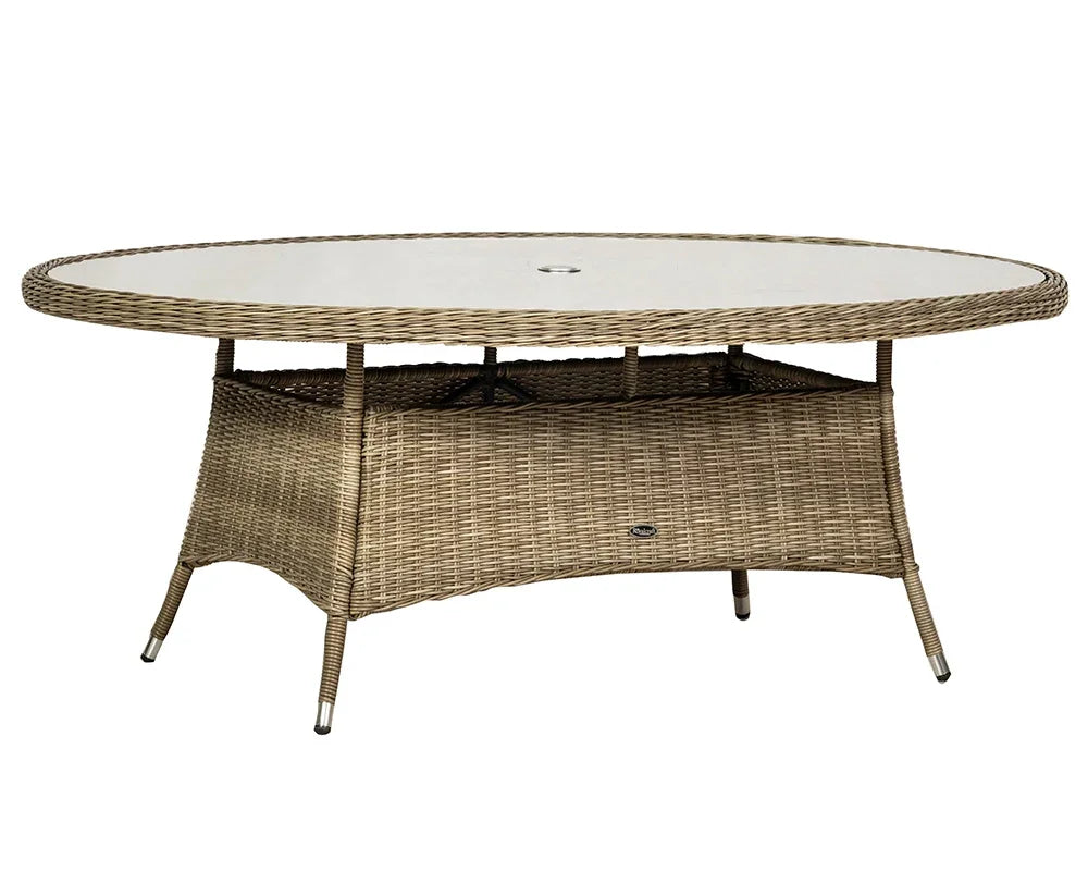 Oval rattan dining table with glass top and central umbrella hole