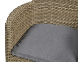 Close view of rattan armchair with grey seat cushion and woven armrest detail