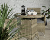 Rattan garden dining set with round glass table and two chairs on tiled floor