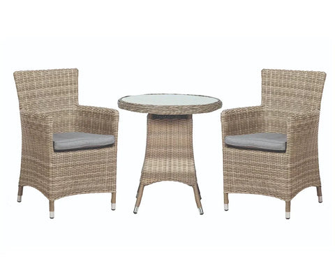 Rattan bistro set with round glass table and two cushioned chairs
