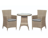 Rattan bistro set with round glass table and two cushioned chairs