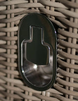 Close-up of rattan garden furniture with integrated metal bottle opener feature