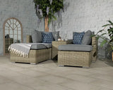 Grey rattan corner sofa set with cushions and coffee table on tiled patio