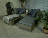 Rattan garden chaise lounge set with grey cushions, scatter pillows and side table