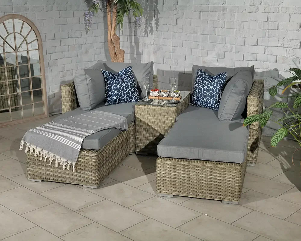 Grey rattan corner sofa set with cushions and glass coffee table in tiled room
