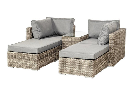Grey rattan outdoor lounge set with cushions and glass side table