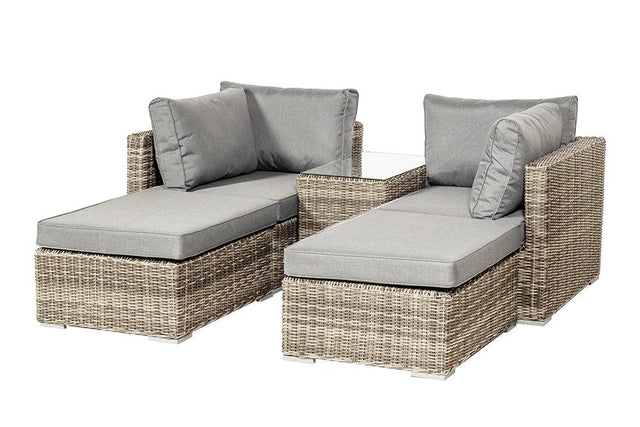 Grey rattan outdoor lounge set with cushions and glass side table