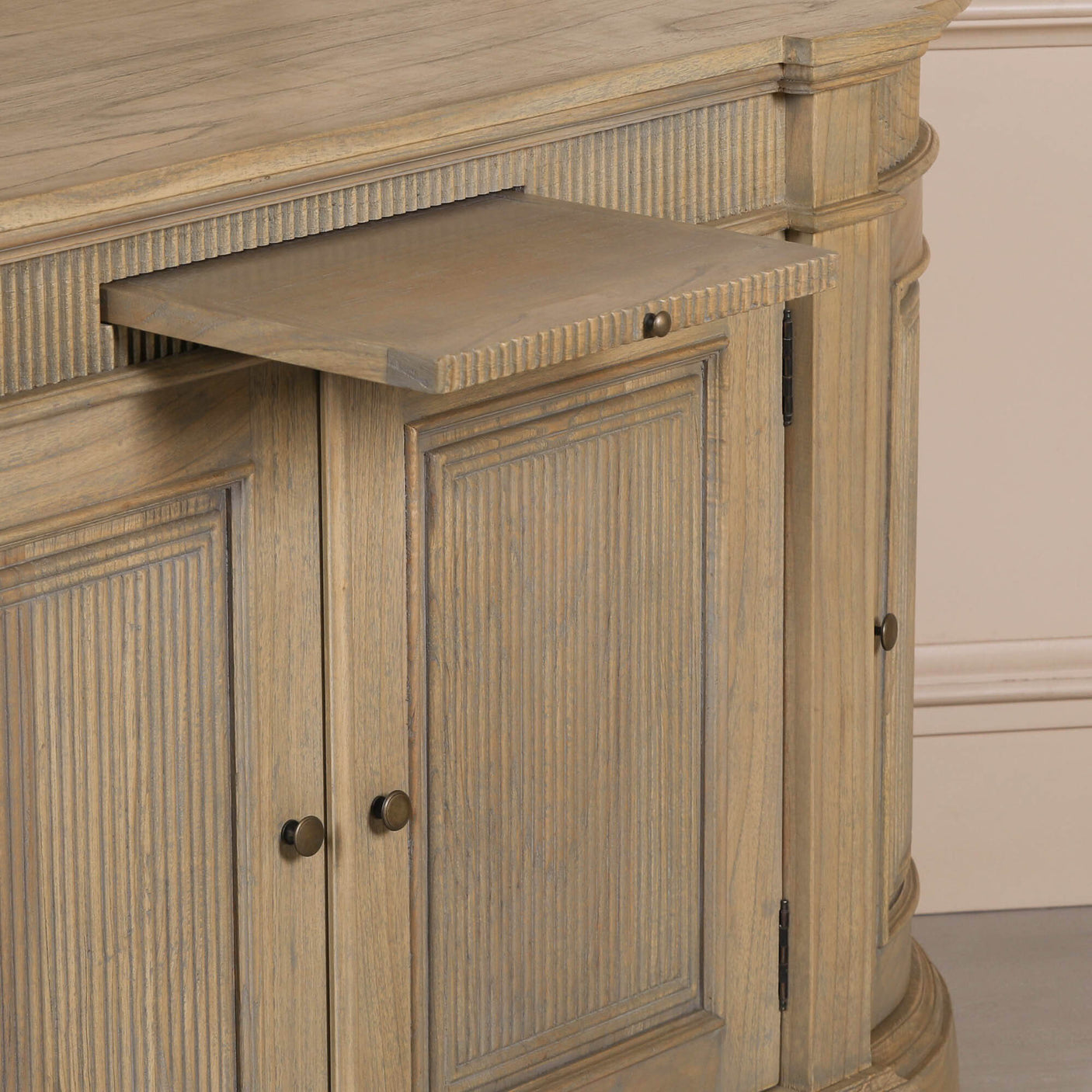 Rustic wooden buffet sideboard with fluted design and a pull-out shelf.