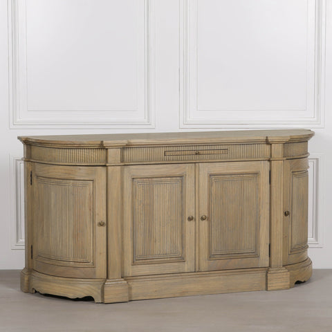 Rustic wooden buffet sideboard with fluted detailing and three cabinet doors.