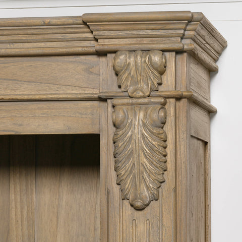 Close-up of the ornate detailing on a large rustic open bookcase.