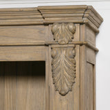 Close-up of the ornate detailing on a large rustic open bookcase.