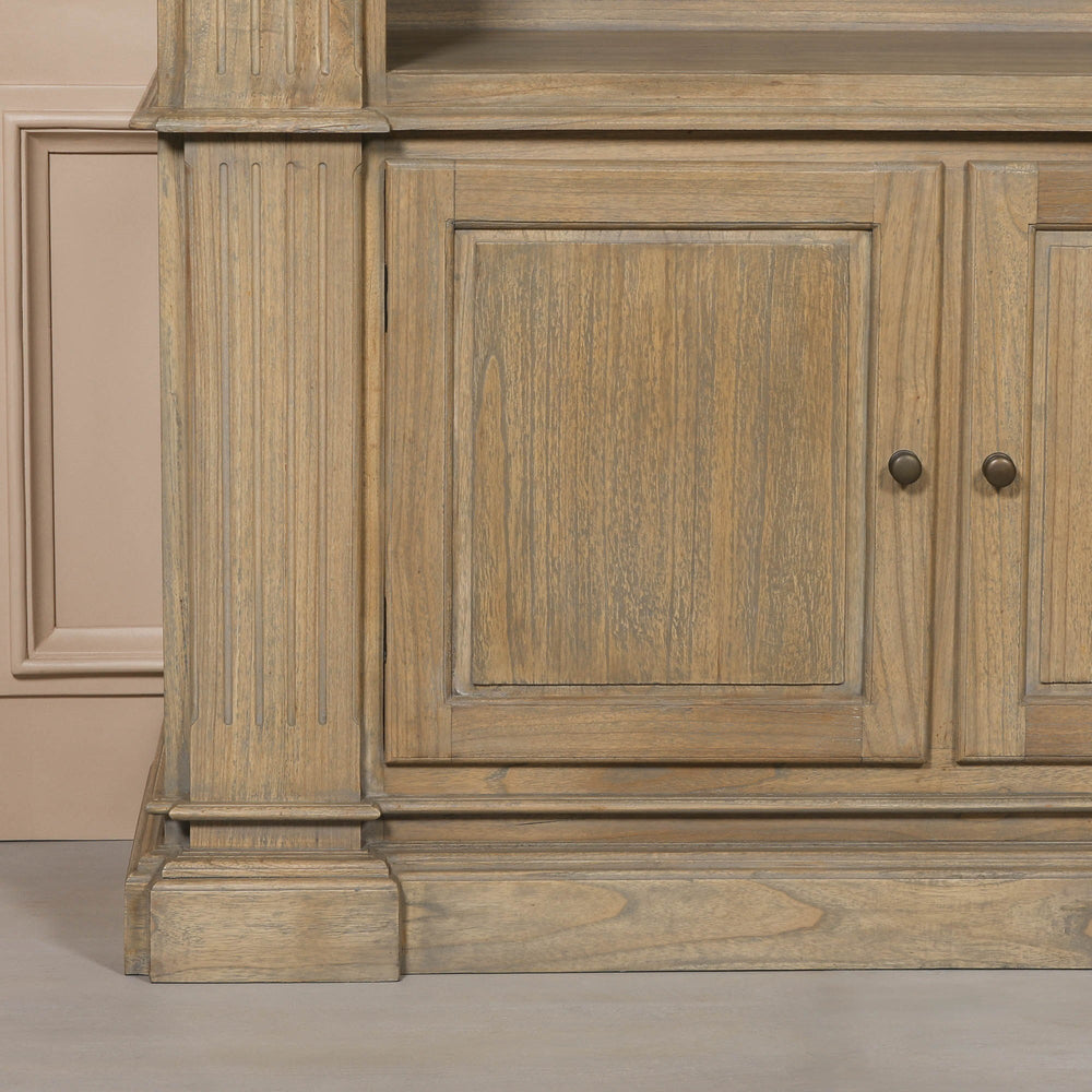 Close-up of the base of a large rustic open bookcase, featuring detailed wood grain and traditional design elements.