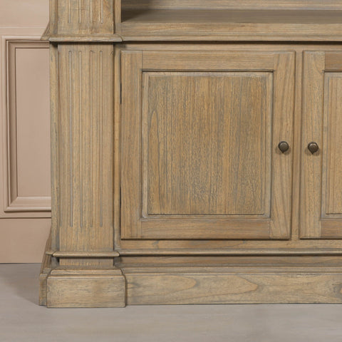 Close-up of the base of a large rustic open bookcase, featuring detailed wood grain and traditional design elements.