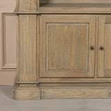 Close-up of the base of a large rustic open bookcase, featuring detailed wood grain and traditional design elements.