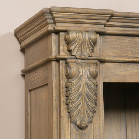 Close-up of the ornate detailing on the top of a large rustic open bookcase.