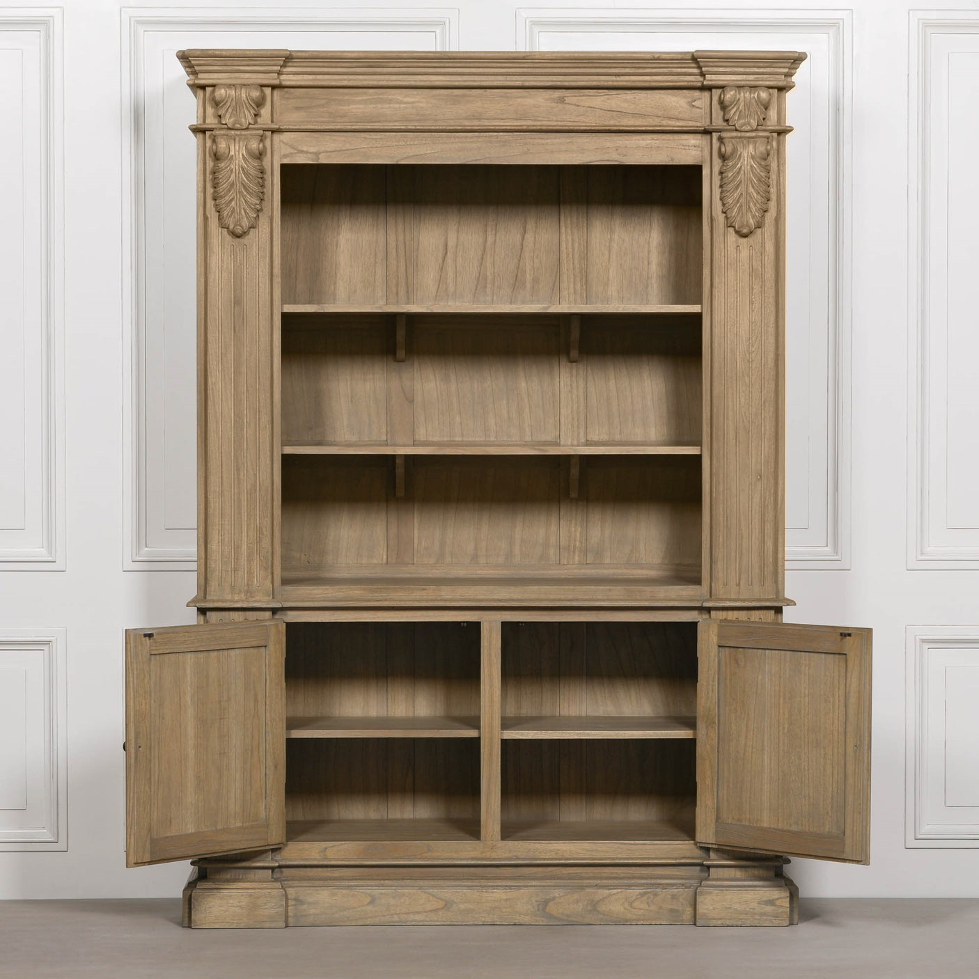 Large rustic open bookcase with multiple shelves and two lower doors, featuring decorative detailing.